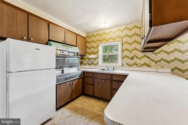 a kitchen with a sink and large window