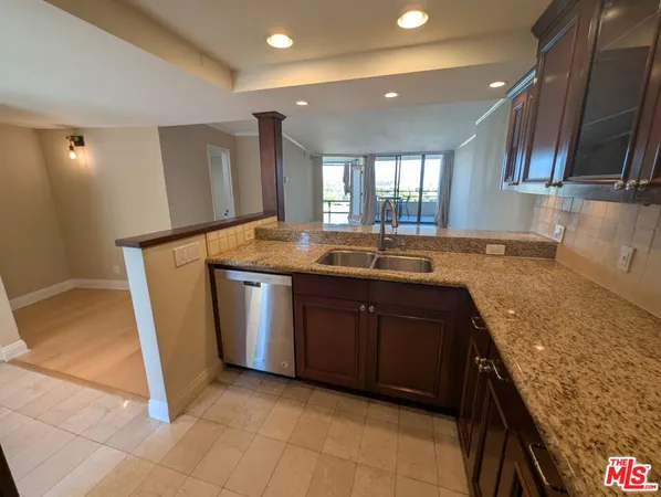 a kitchen with granite countertop a sink and a stove
