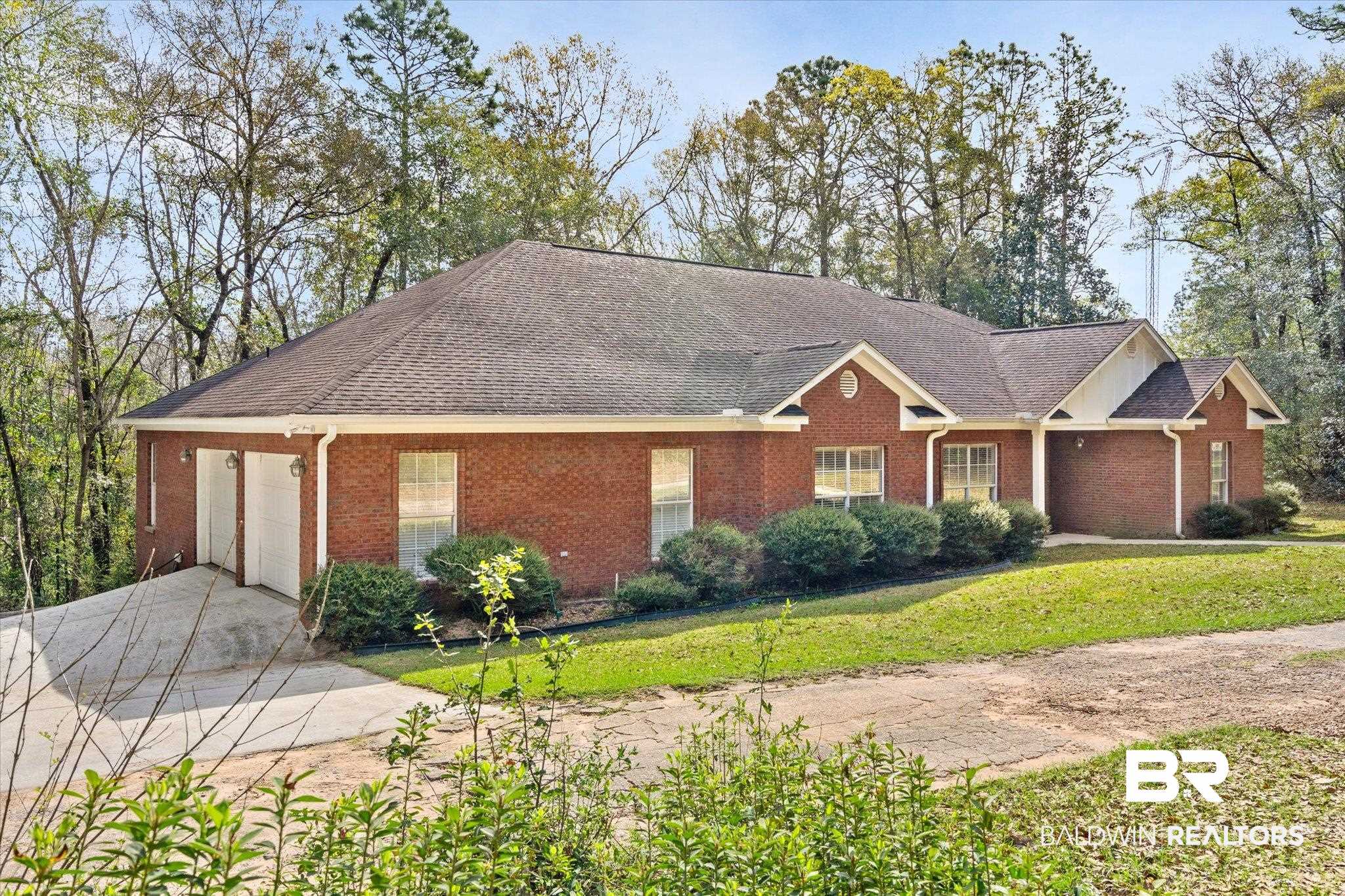 2400 Waterford Road Semmes, AL 36575 - Photo 29 of 30 Ranch-style home featuring concrete driveway, brick siding, an attached garage, a front yard, and roof with shingles