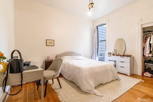 a bed sitting in a bedroom next to a window