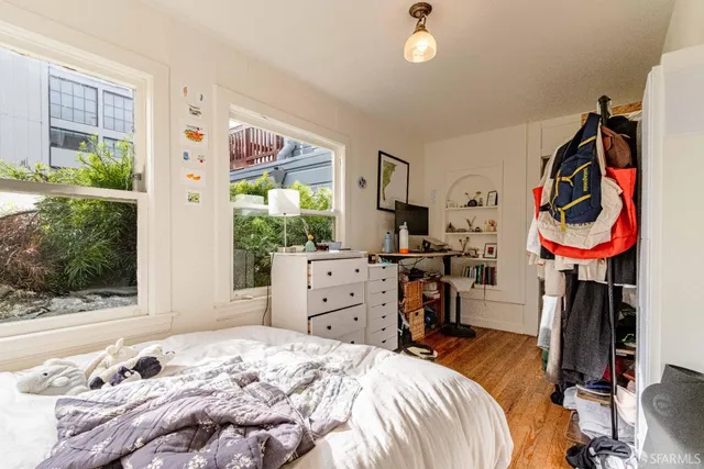 a view of a lake with lawn chairs and potted plants