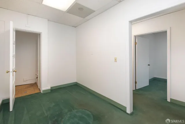 a front view of a residential apartment building with a yard