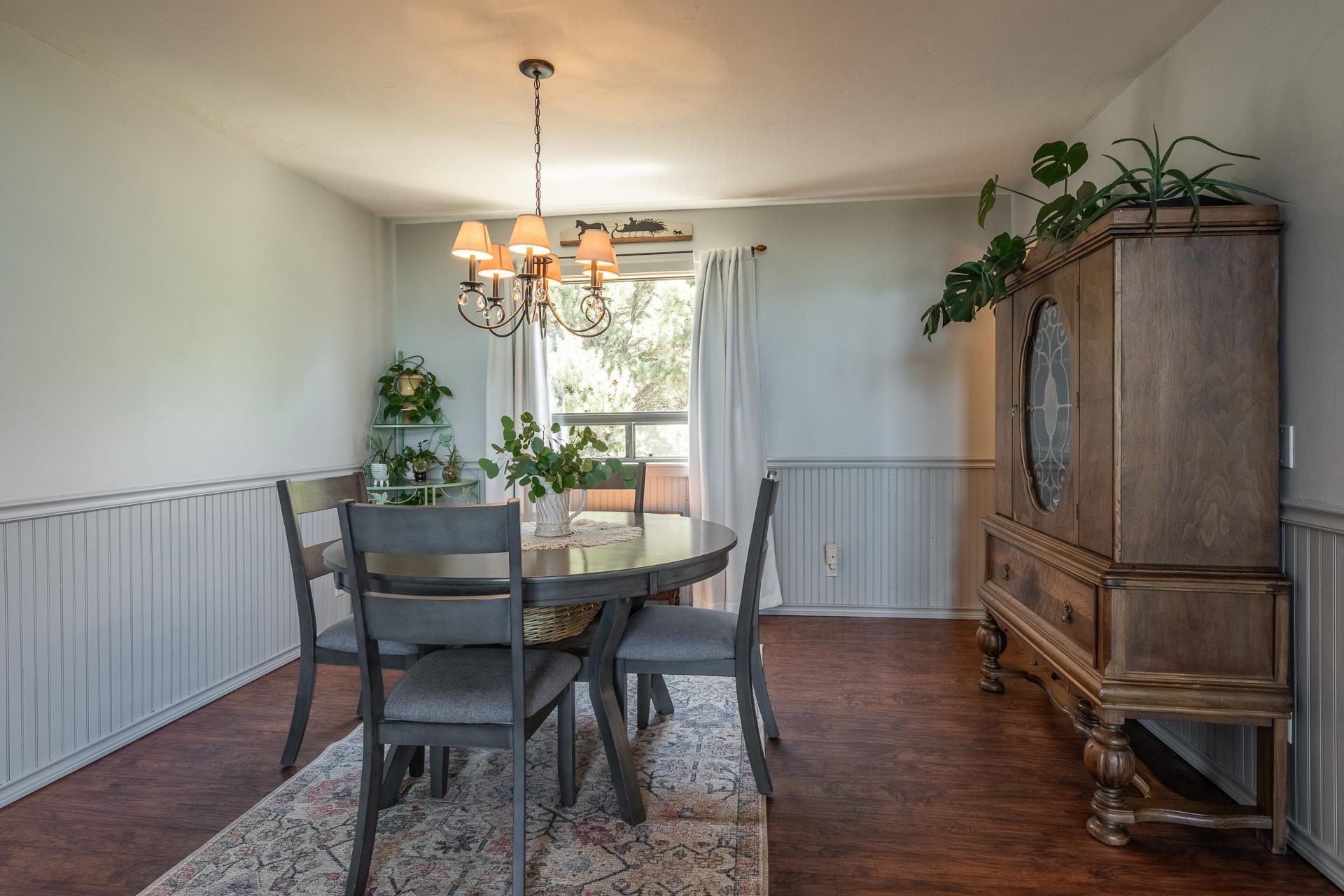 537 Aspen Spring Ranch Road Mammoth Lakes, CA 93546 - Photo 7 of 40 Dining area featuring a classic chandelier, wood-finish flooring, and wainscoting