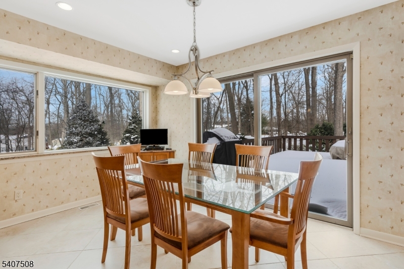 855 Sunset Ridge Bridgewater, NJ 08807 - Photo 17 of 39 a dining room with furniture a chandelier and a rug