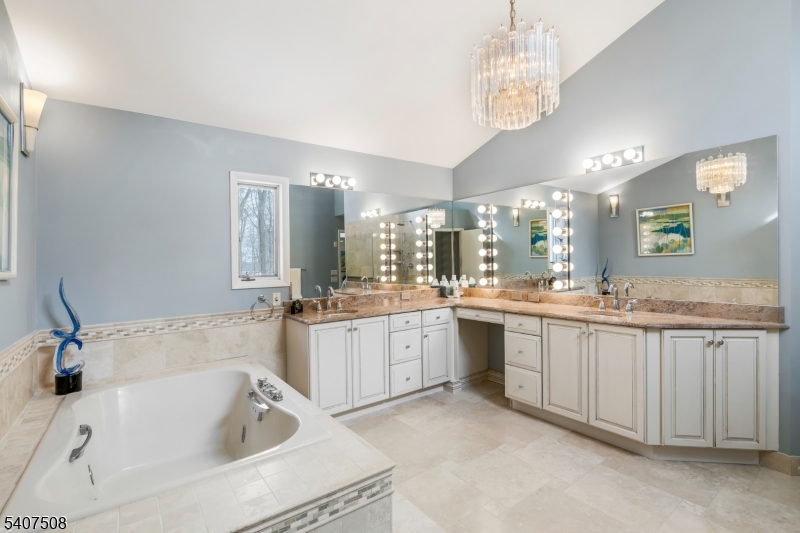 855 Sunset Ridge Bridgewater, NJ 08807 - Photo 25 of 39 a spacious bathroom with a granite countertop sink mirror and bathtub