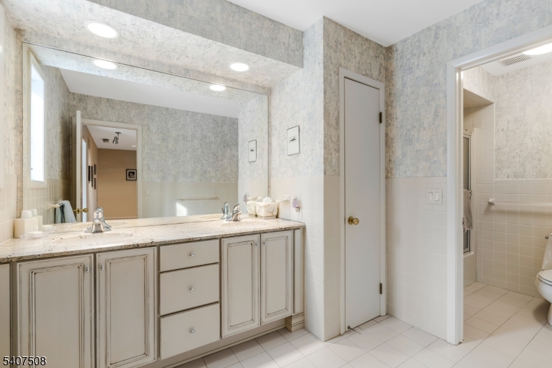 855 Sunset Ridge Bridgewater, NJ 08807 - Photo 28 of 39 a bathroom with a double vanity sink and mirror