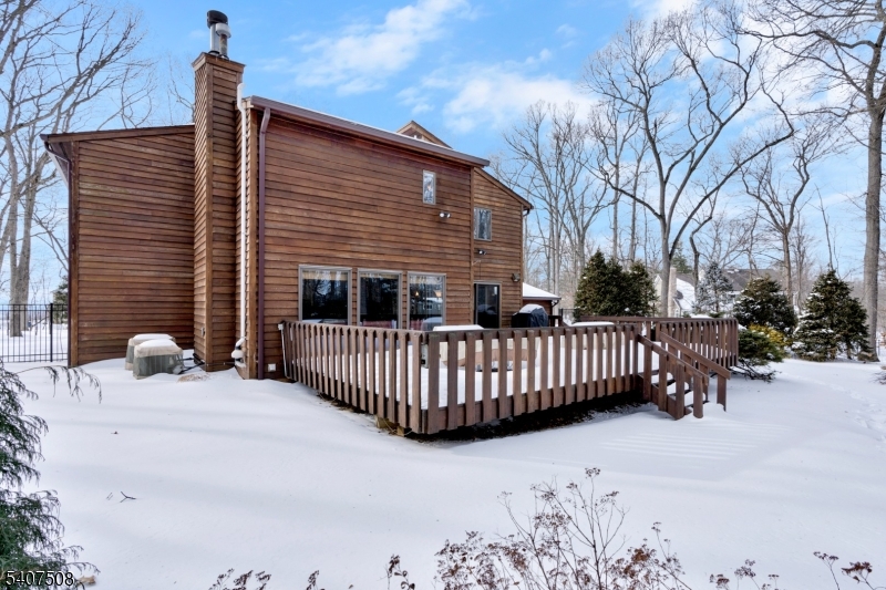 855 Sunset Ridge Bridgewater, NJ 08807 - Photo 36 of 39 a view of a house with a wooden bench in snow