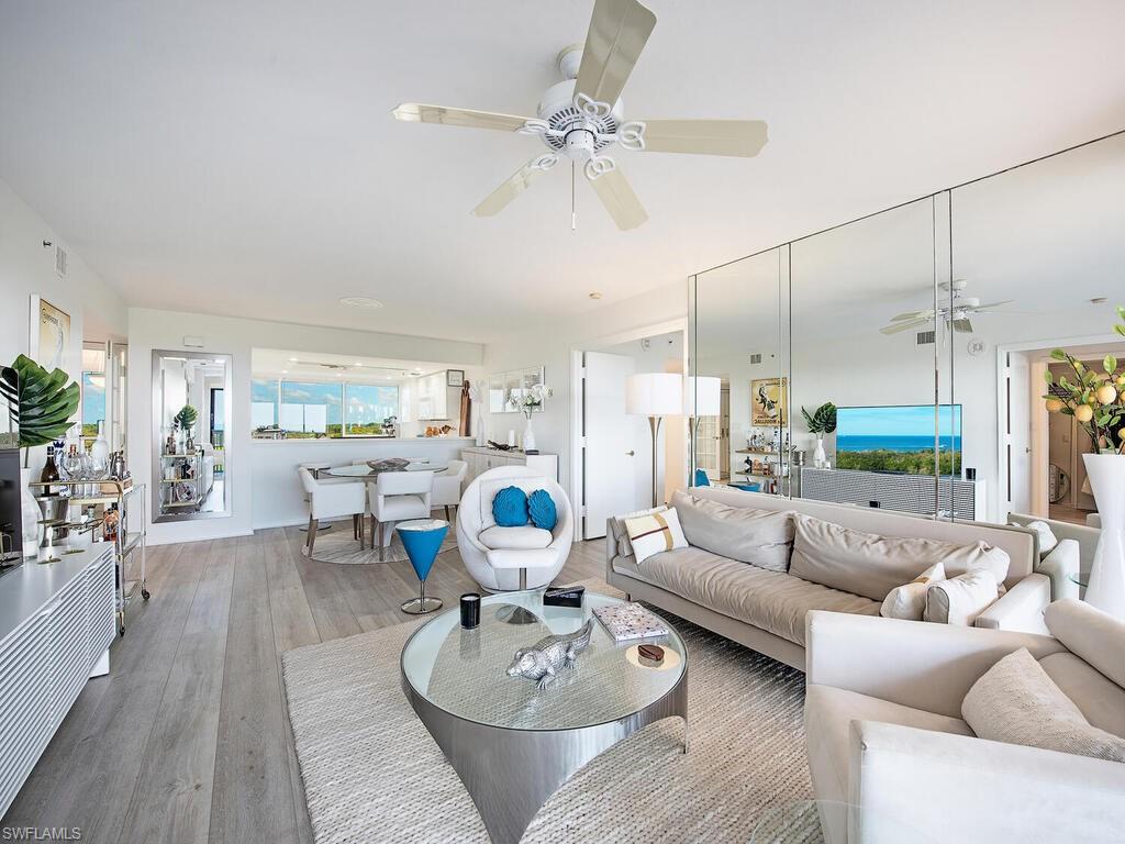 6825 Grenadier Boulevard, Unit 604 Naples, FL 34108 - Photo 3 of 12 a living room with furniture and a large window