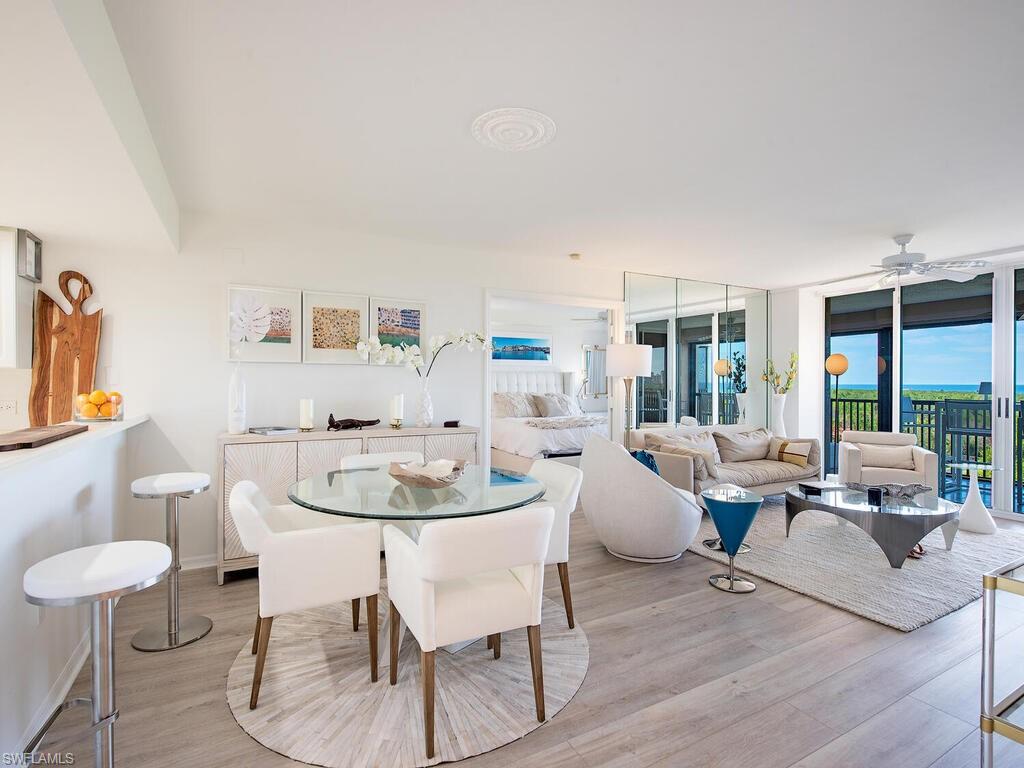 6825 Grenadier Boulevard, Unit 604 Naples, FL 34108 - Photo 4 of 12 a living room with furniture and a large window