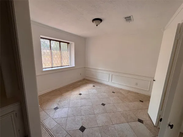 a view of an empty room and a window