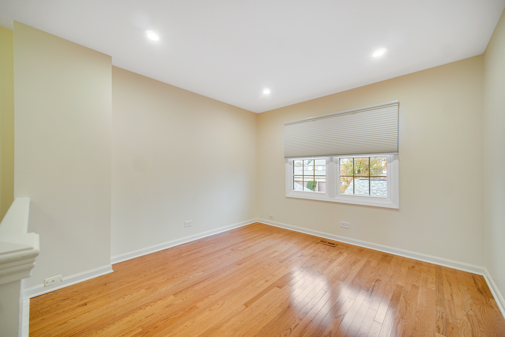 1130 Oakview Drive Wheaton, IL 60187 - Photo 16 of 25 a view of an empty room with wooden floor and a window
