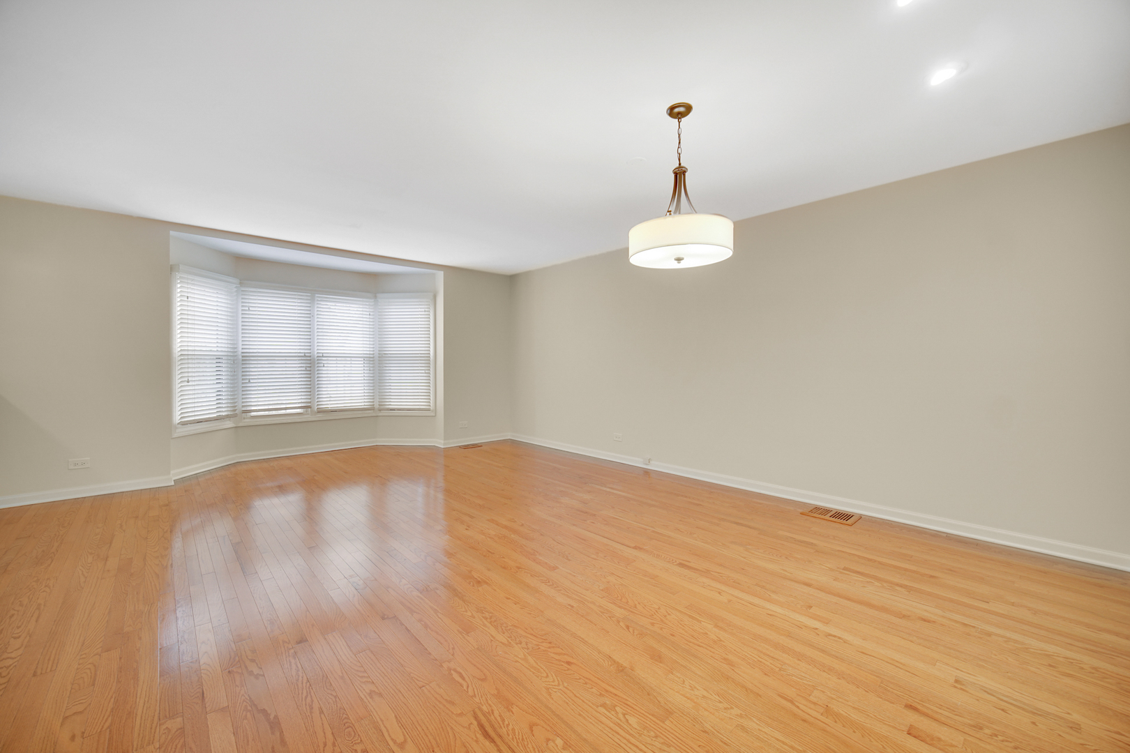 1130 Oakview Drive Wheaton, IL 60187 - Photo 5 of 25 wooden floor in an empty room with a window