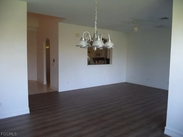 a view of a room with wooden floor and natural light