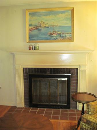 179 Heatherstone Road Amherst, MA 01002 - Photo 8 of 10 a living room with a fireplace and a bookshelf