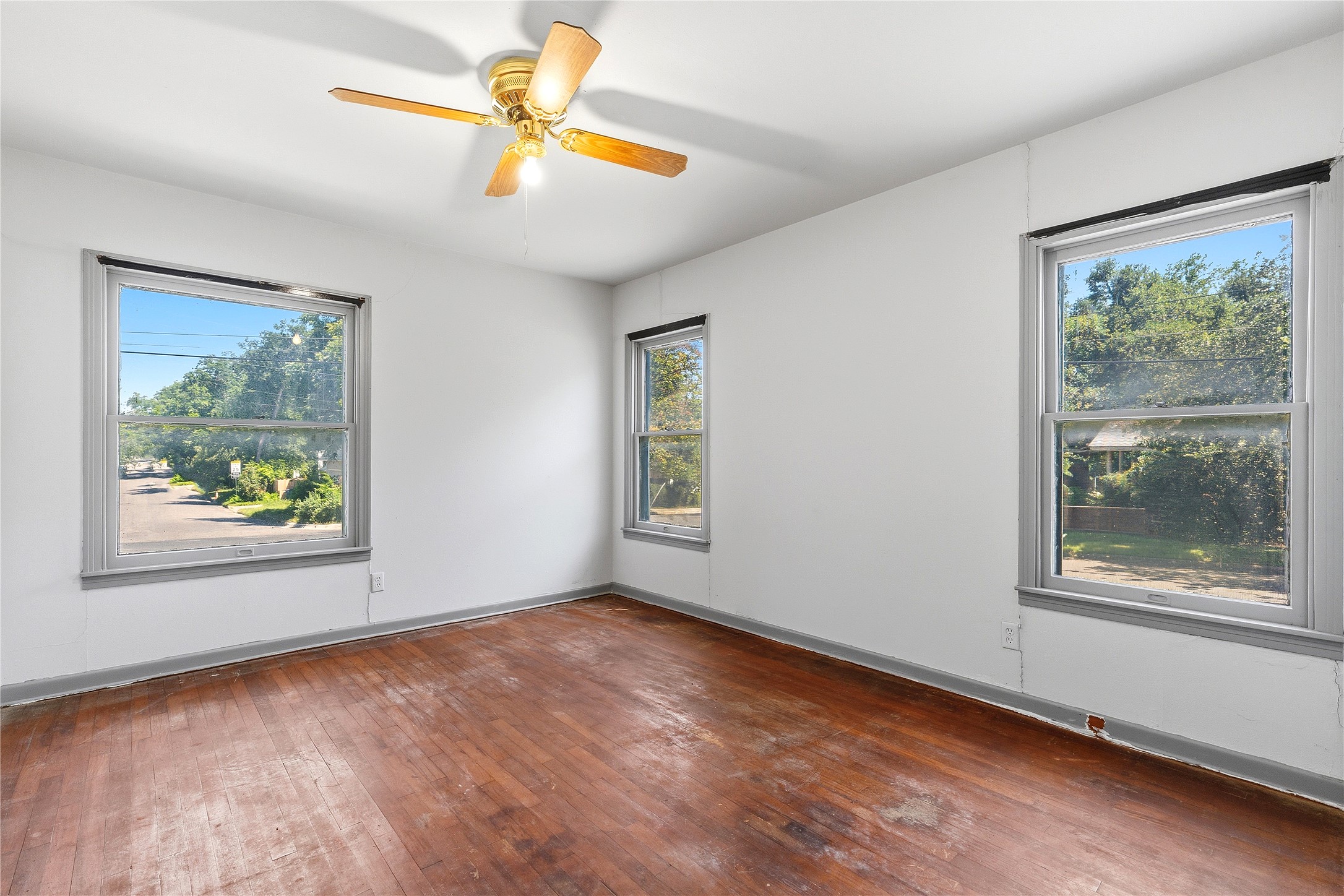 4900 Duval Street Austin, TX 78751 - Photo 18 of 25 Bedroom with original 1950s wood windows, oak floors, and vintage molding. One of three generously sized bedrooms, this space offers natural light, period character, and clear potential for restoration.