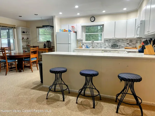 a view of swimming pool with lake and houses in the back