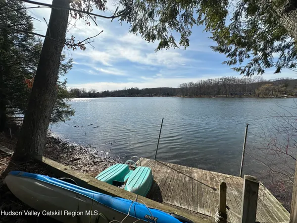 a kitchen with stainless steel appliances granite countertop a sink a stove a refrigerator and cabinets