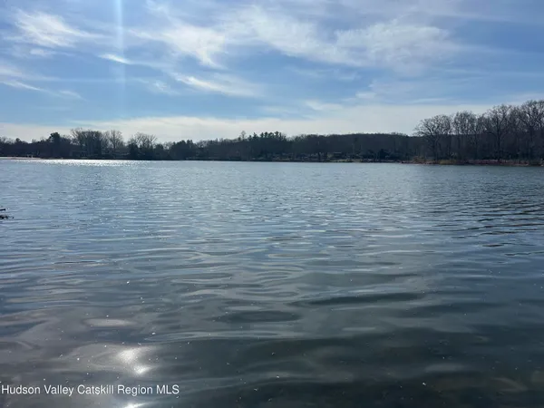 a bedroom with a bed and painting on the wall