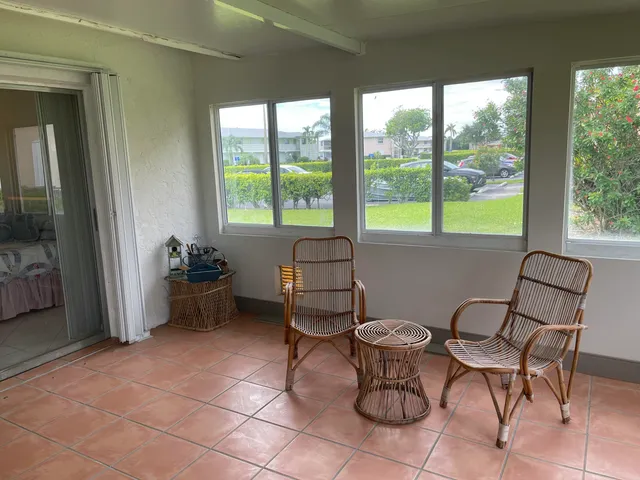 a living room with a couple of furniture and a window