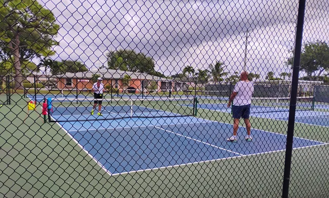 a dining room with stainless steel appliances kitchen island granite countertop a dining table chairs and a oven