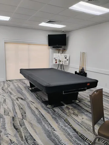 a view of a big house with wooden fence