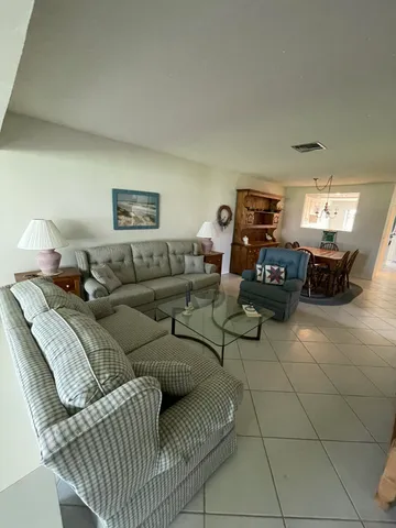 a living room with furniture a window and a flat screen tv
