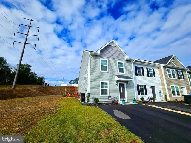 a living room with furniture a rug and a painting on the wall