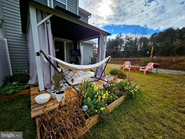 a view of a house with backyard porch and sitting area