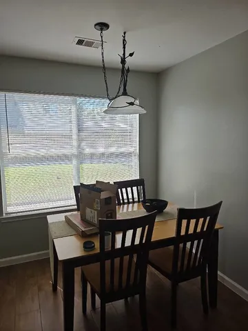 a view of a dining room with furniture window and wooden floor