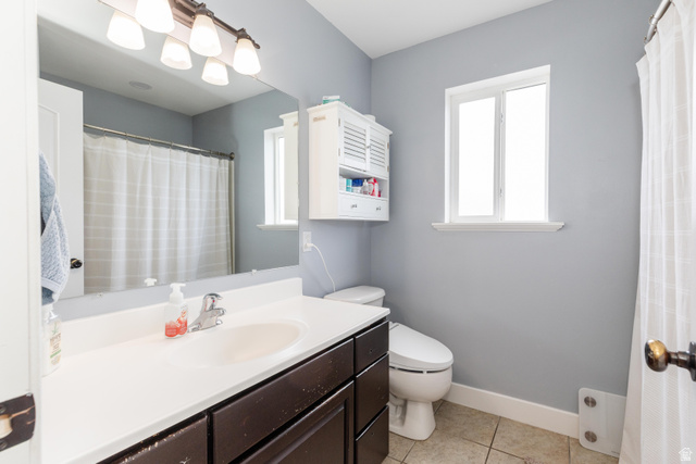 972 West 2840th Street South Logan, UT 84321 - Photo 15 of 46 Bathroom vanity with a white countertop and oval undermount sink, complemented by a large wall mirror and a five-light fixture