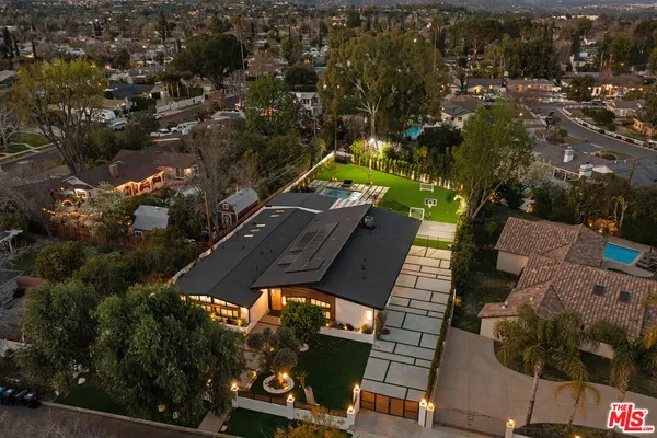 an aerial view of a house with a yard and lake view