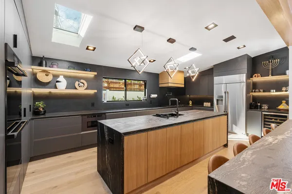 a kitchen with stainless steel appliances granite countertop a sink and a stove