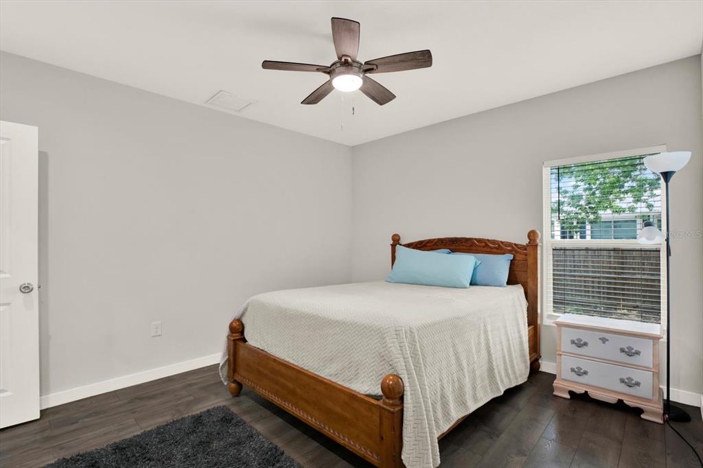3023 Muir Street Holiday, FL 34691 - Photo 17 of 25 a bedroom with a bed and a ceiling fan