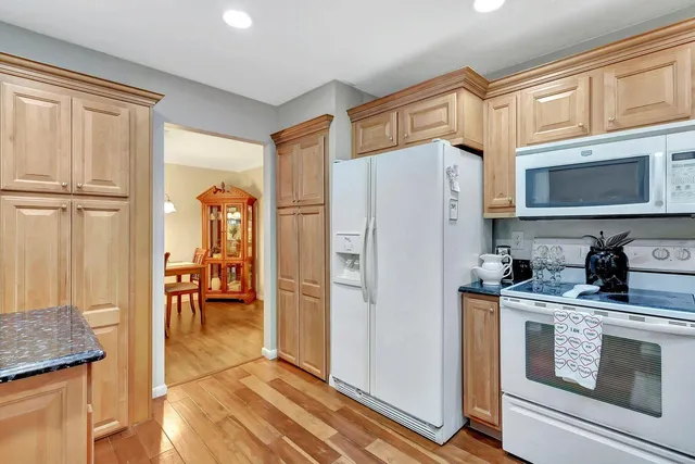 a kitchen with stainless steel appliances a refrigerator a stove a sink and a cabinets