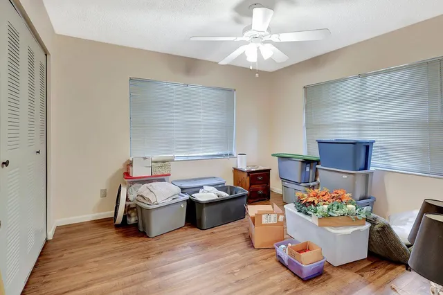 a bedroom with furniture and a wooden floor
