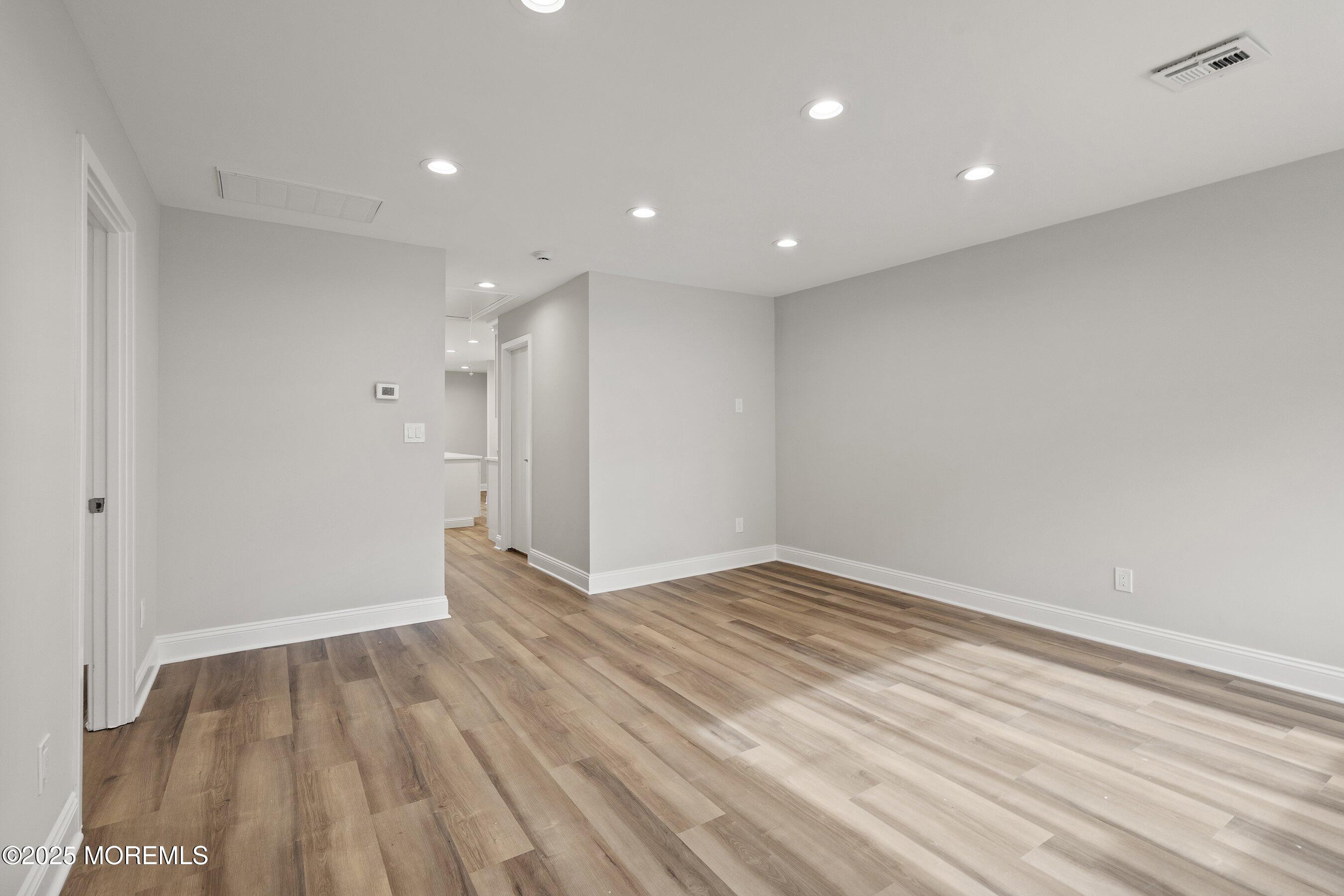 122 West 6th Street Howell, NJ 07731 - Photo 13 of 20 a view of an empty room with wooden floor