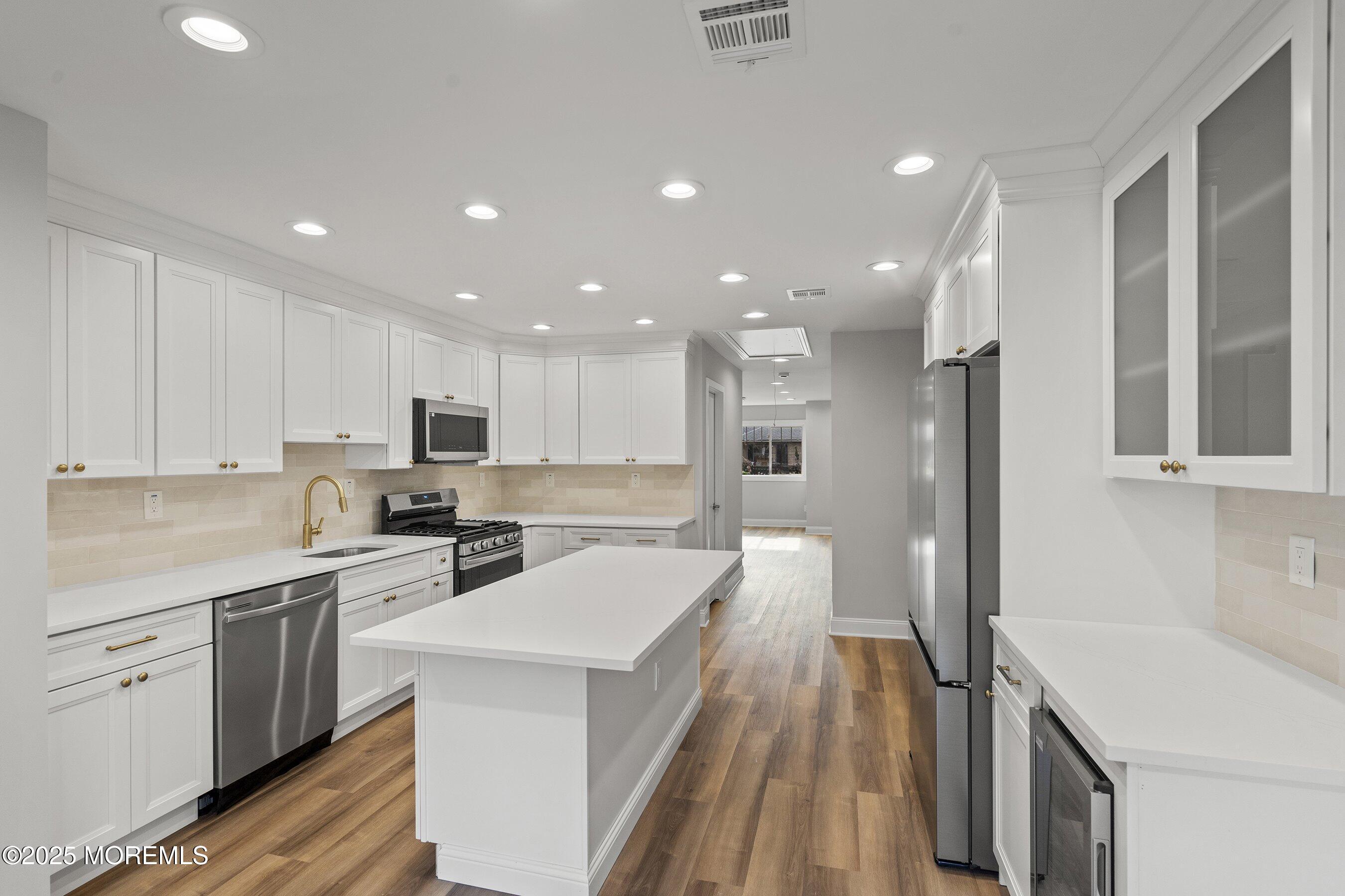 122 West 6th Street Howell, NJ 07731 - Photo 14 of 20 a kitchen with a sink a counter top space stainless steel appliances and cabinets