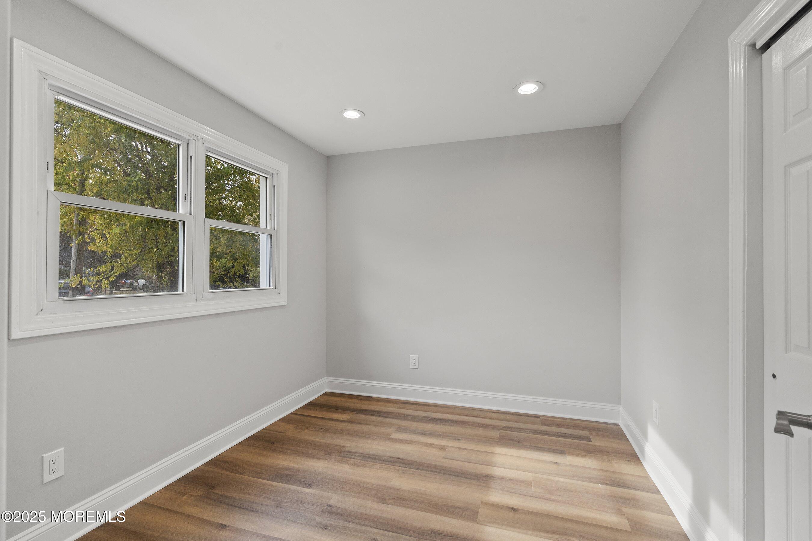 122 West 6th Street Howell, NJ 07731 - Photo 16 of 20 a view of empty room with wooden floor and fan