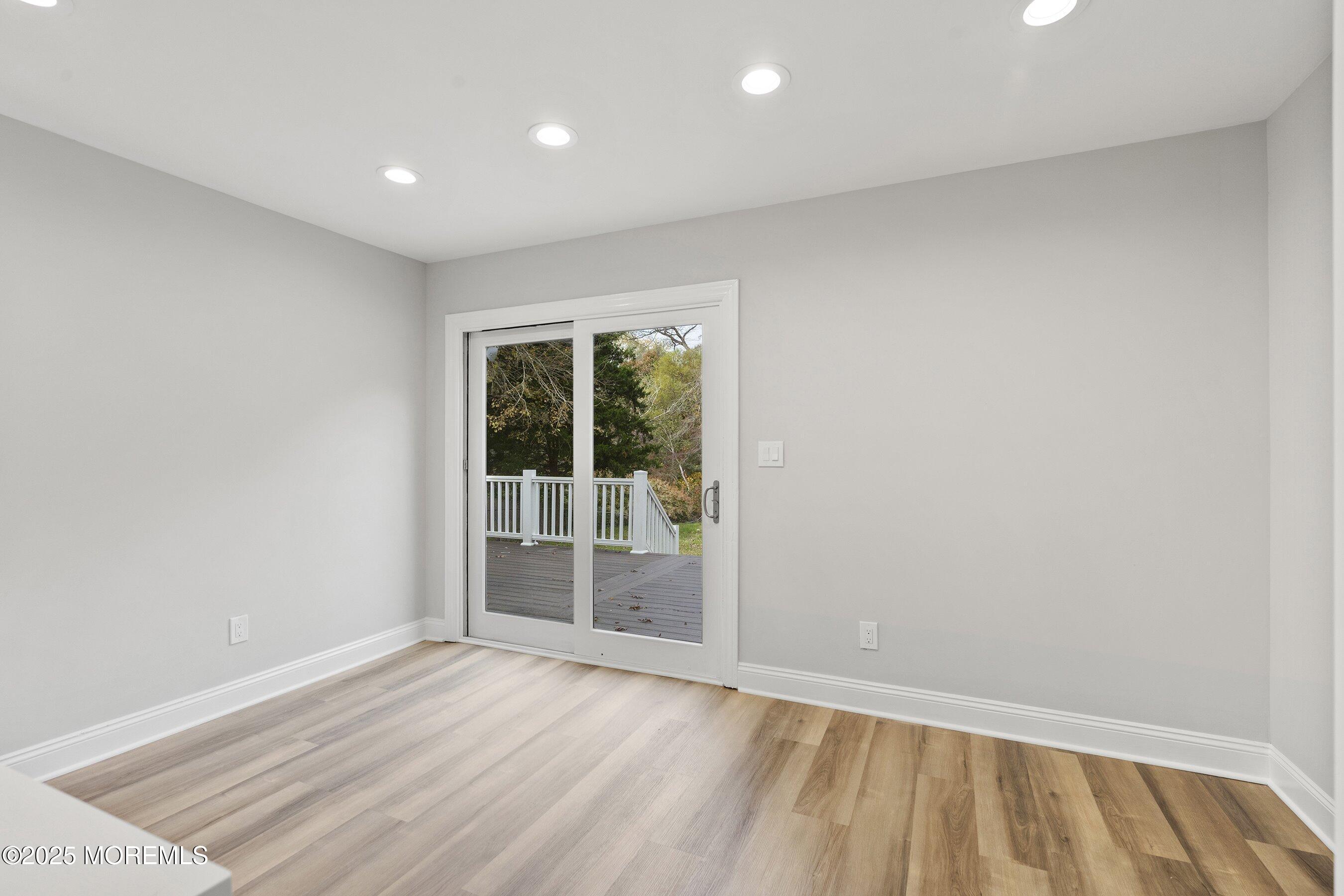 122 West 6th Street Howell, NJ 07731 - Photo 18 of 20 an empty room with wooden floor and windows