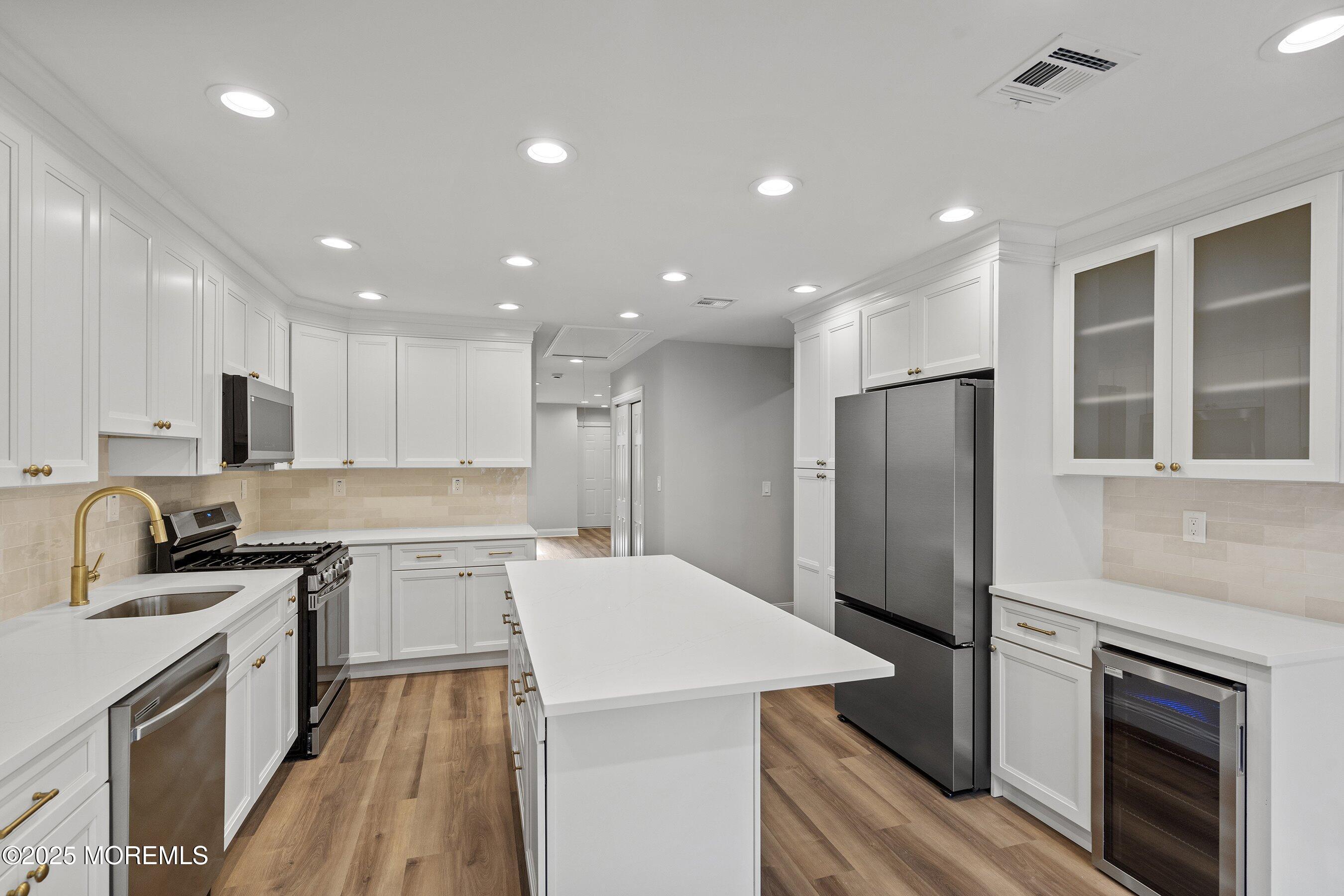 122 West 6th Street Howell, NJ 07731 - Photo 5 of 20 a kitchen with refrigerator a sink and cabinets