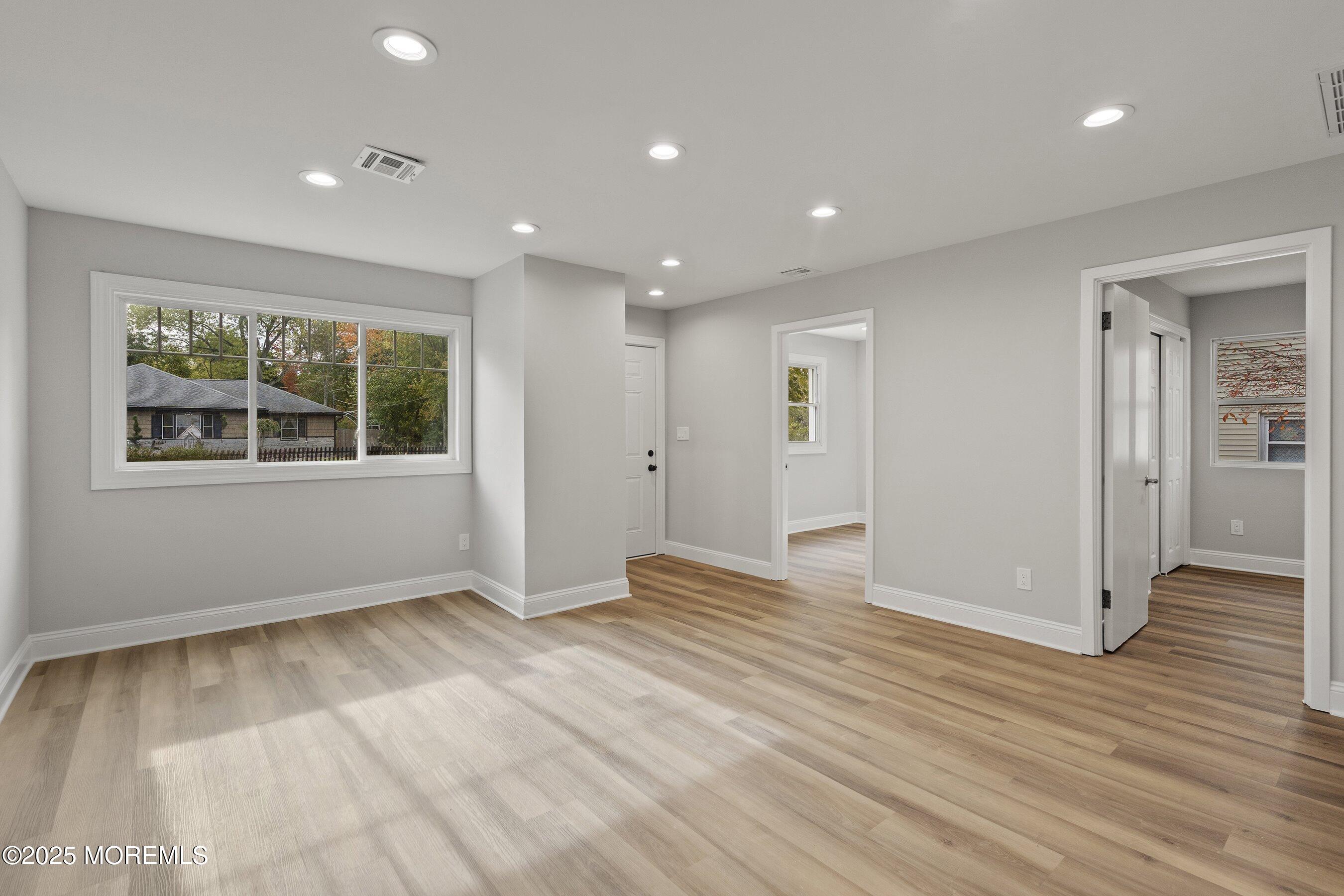 122 West 6th Street Howell, NJ 07731 - Photo 6 of 16 a view of an empty room with wooden floor and windows