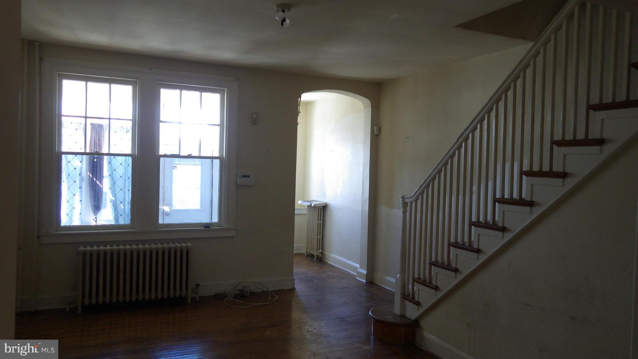 6055 Harford Road Baltimore, MD 21214 - Photo 4 of 13 wooden floor in an empty room with wooden floor and windows