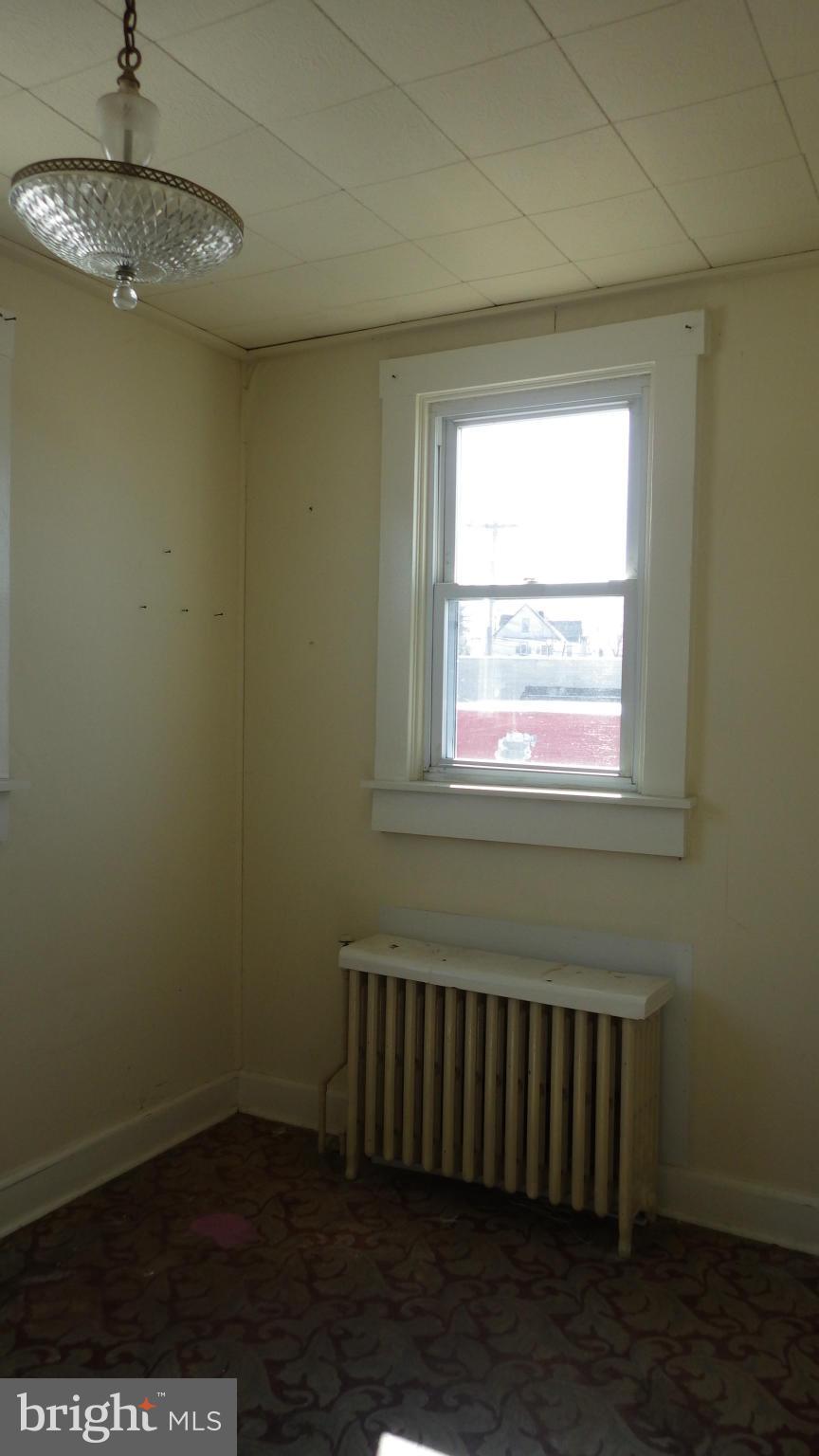 6055 Harford Road Baltimore, MD 21214 - Photo 9 of 13 a view of a room with wooden floor and a window