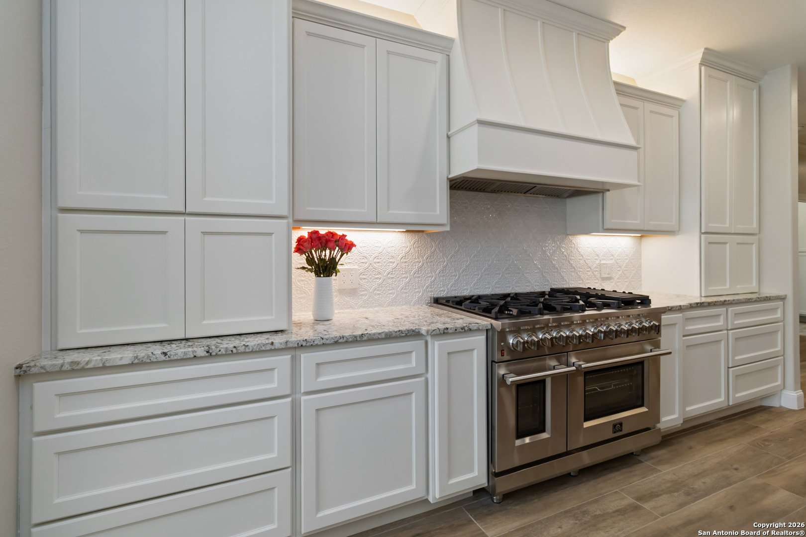 43 Lost Valley Boerne, TX 78006 - Photo 14 of 61 a kitchen with granite countertop white cabinets and stainless steel appliances