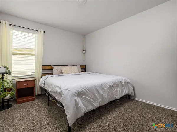 a bedroom with a bed and a fireplace