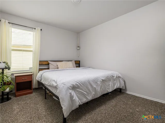 a bedroom with a bed and a fireplace