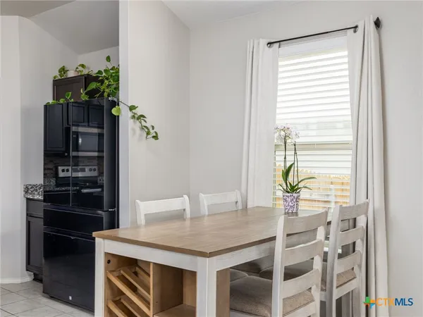 a kitchen with a table and chairs