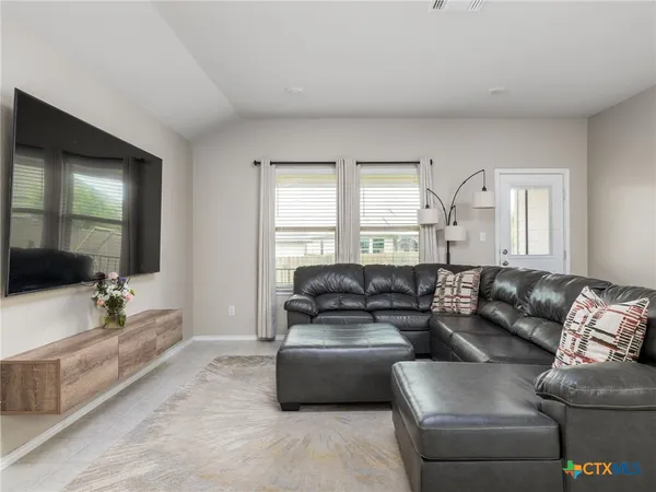 a living room with furniture and a large window
