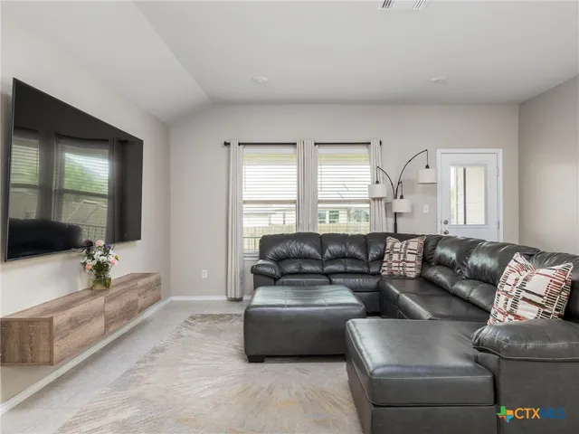 a living room with furniture and a large window