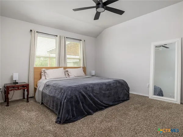 a bedroom with a bed and window